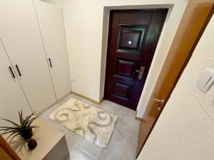 a hallway with a door and a rug at SkyLux Premium Zenica in Zenica +21 photos