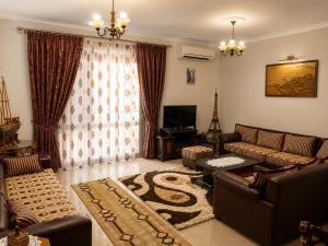 a living room with a couch and a table and a television at Berat Skyline Apartment in Berat