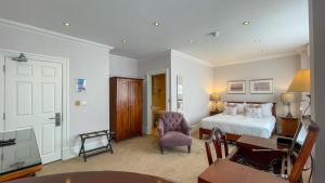 a hotel room with a bed and a desk and a chair at The Redstone Guesthouse in Blackpool +20 photos
