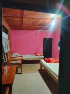 a room with two bunk beds and a table at Hillside Highway Cottages in Shillong