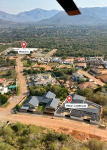 an aerial view of a city with buildings and mountains at Hanan Guesthouse in Thabazimbi