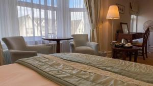 a hotel room with a bed and a table and chairs at The Redstone Guesthouse in Blackpool