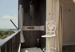 a white chair sitting on a balcony at Seaview Beach Residence Malgrat de Mar in Malgrat de Mar