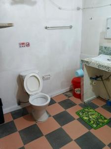 a bathroom with a toilet and a sink at The Cronin Residence in Oslob
