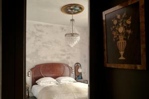 a bedroom with a bed and a chandelier at Seaview Beach Residence Malgrat de Mar in Malgrat de Mar