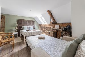 a living room with two beds and a couch at Gîte de la Cour in Campandré-Valcongrain +101 photos