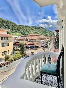 a chair on a balcony with a view of a city at Anara Sapa Hotel in Sapa