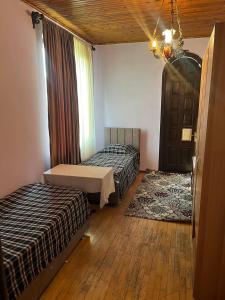 a room with two beds and a window and a door at Chavchavadze 56 in Kobuleti