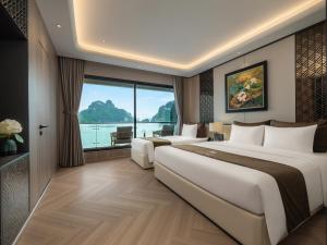 a hotel room with two beds and a large window at Azura Cruise in Ha Long +98 photos