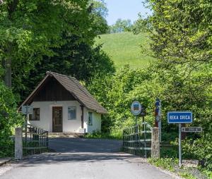 a small house with a sign in front of a road at Zacisze nad Orlicą in Międzylesie