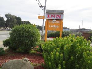 a sign for a luana lodge on the side of a road at Laguna Lodge in Marina