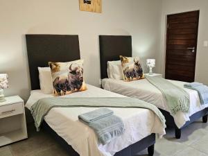 a bedroom with two beds with towels on them at Wave Dancer 2-Bedroom Apartment in St Lucia