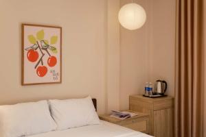 a bedroom with a bed and a picture of fruit at Tổ Homestay in Thôn Kim Long (1)