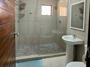 a bathroom with a shower and a sink at Wave Dancer 2-Bedroom Apartment in St Lucia +15 photos