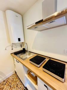 a small kitchen with a sink and a stove at Corte Gelsomino in Susa