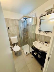 a bathroom with a shower and a toilet and a sink at Corte Gelsomino in Susa