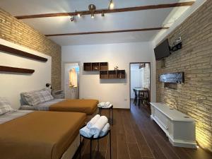 a bedroom with two beds and a brick wall at RELAIS dei TRABOCCHI in Casalbordino