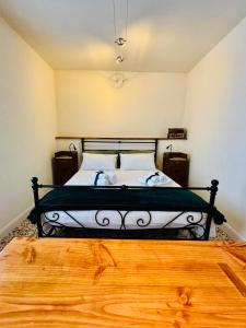 a bedroom with a black and white bed with a wooden floor at Corte Gelsomino in Susa +7 photos