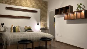 a bedroom with a bed with two black stools at RELAIS dei TRABOCCHI in Casalbordino