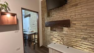 a bathroom with a stone wall with a television on it at RELAIS dei TRABOCCHI in Casalbordino +19 photos