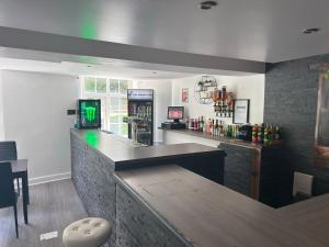 a bar in a restaurant with a counter and aperature at Wool Merchant Hotel HALIFAX in Halifax