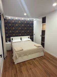 a bedroom with a large bed and a wall at Seba Deluxe Home in Puerto de Santiago +39 photos