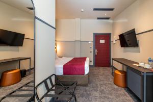 a hotel room with a bed and a tv at NOBO - Hotel in old Tbilisi in Tbilisi City