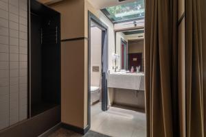 a bathroom with a sink and a toilet and a mirror at NOBO - Hotel in old Tbilisi in Tbilisi City +50 photos