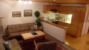 a living room with a couch and a table at Schneiderhof in Rimsting
