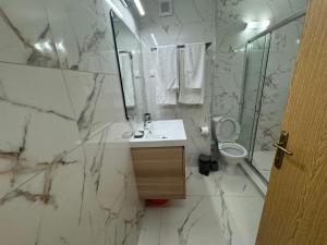 a bathroom with a sink and a toilet and a mirror at Turtle Apartment Sunny Beach in Sunny Beach +32 photos
