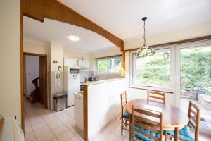 a kitchen and dining room with a table and chairs at Maison Bellevue in Brunstatt