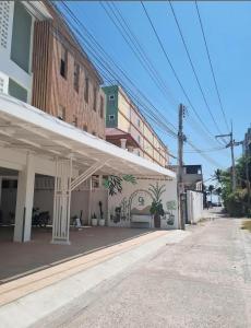 a building with a white awning on a street at O2 Bangsaen in Ban Bang Saen (1)