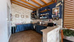 a kitchen with blue cabinets and a blue counter top at Guesthouse HHL - Liman ll in Ulcinj