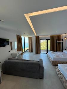 a large room with two beds and a couch at Borsh sunset apartments in Borsh
