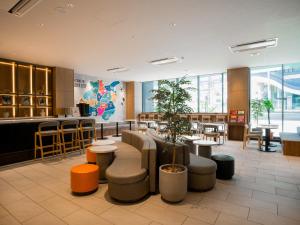 a restaurant with tables and chairs and a bar at SONO Moon Nagoya in Nagoya