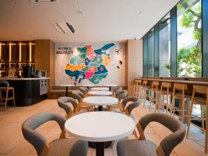 a restaurant with tables and chairs and a map on the wall at SONO Moon Nagoya in Nagoya +42 photos
