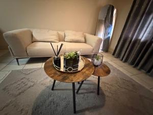 a living room with a couch and a coffee table at Malwandla 1bed full apartment in Centurion