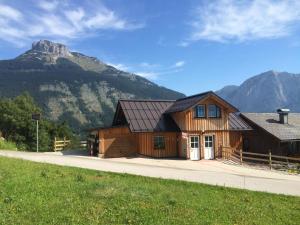 a wooden house with a mountain in the background at Apartment Altaussee in Altaussee