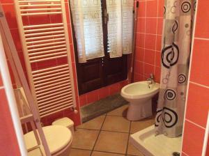 a small bathroom with a toilet and a sink at Casaria da Adry in Cannobio +26 photos
