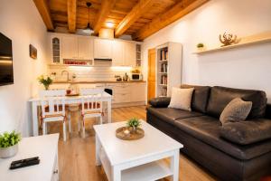a living room with a couch and a table at Apartmán Jezerné in Velké Karlovice