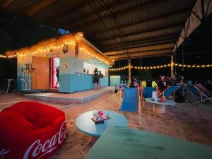 a room with a coca cola bar with people in it at Tinyhouse ATELIÉR u Těrlické přehrady in Horní Těrlicko