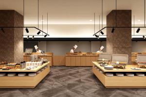 a restaurant with two chefs in the middle of a room at Ooedo Onsen Monogatari Premium Minoh Kanko Hotel in Minoo