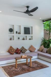a living room with a couch and a coffee table at Sealuna Villas in Tanah Lot