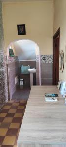 a bathroom with a sink and a toilet in a room at DAIFLAH Guesthouse & Hostel in Oulad Rguia