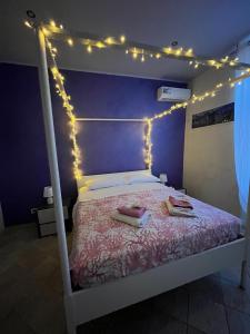 a bedroom with a bed with lights on it at Il Corallo in Terracina +80 photos