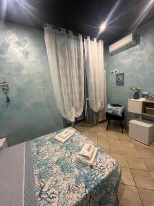 a bedroom with a bed with two towels on it at Il Corallo in Terracina