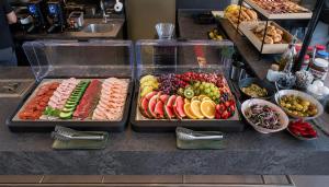 two trays of different types of food on a counter at VISIONAPARTMENTS Wolframplatz - self check-in in Zurich