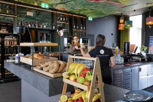 two women are standing at a counter in a bakery at VISIONAPARTMENTS Wolframplatz - self check-in in Zurich +108 photos