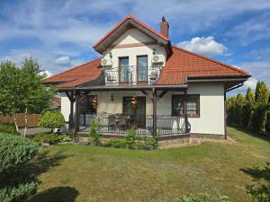 a house with a balcony on a yard at Białowieski Raj in Białowieża