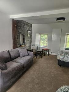 a living room with a couch and a bed at The Hedgerow Kilshanny in Kilshanny